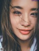 A close up of a woman with long brown hair.