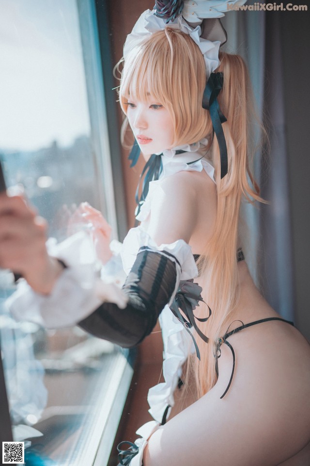 A woman in a maid outfit is looking out a window.