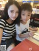 A woman and a boy sitting at a table in a restaurant.