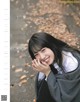 A young woman with long black hair smiles at the camera.